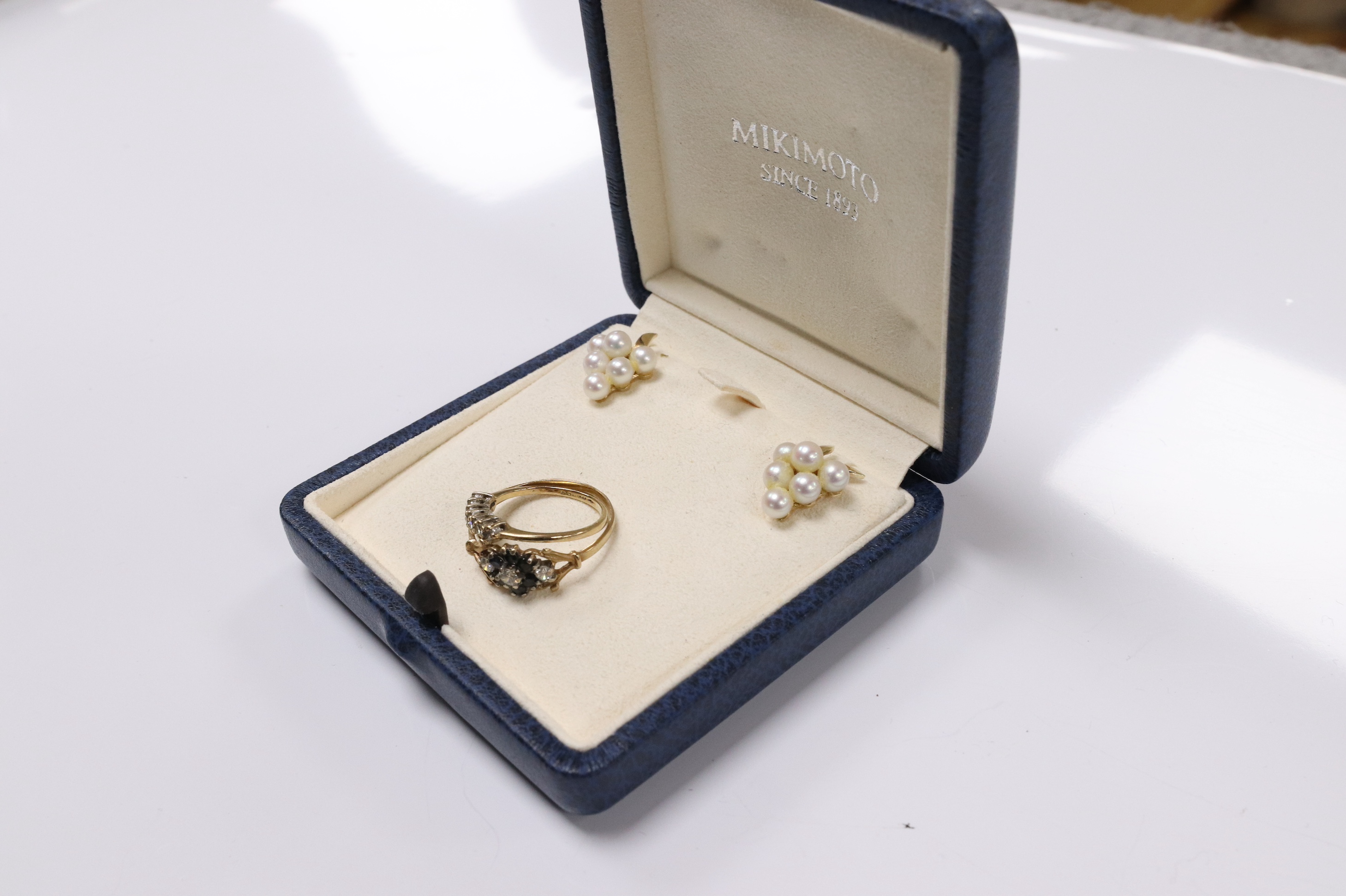 A modern pair of 375 and cluster pearl cluster set earrings, 17mm, in a Mikimoto box, (earrings not signed), together with two modern 9ct gold and gem set rings. Condition - fair